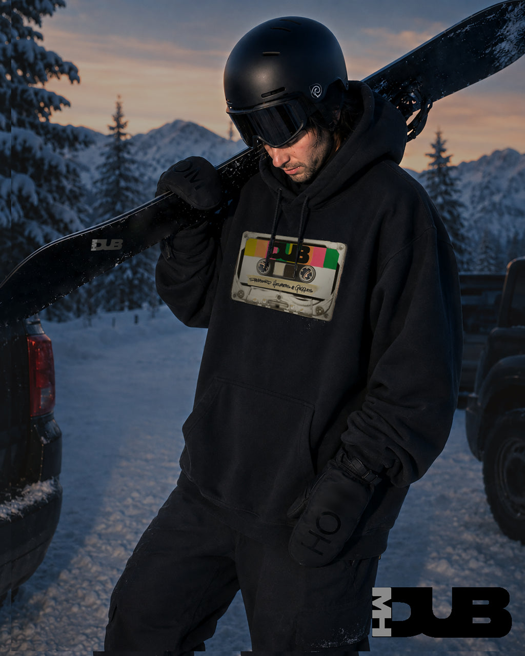 snowboarder in black hoodie  with helmet and goggle, standing in a snowy landscape with sunrise.