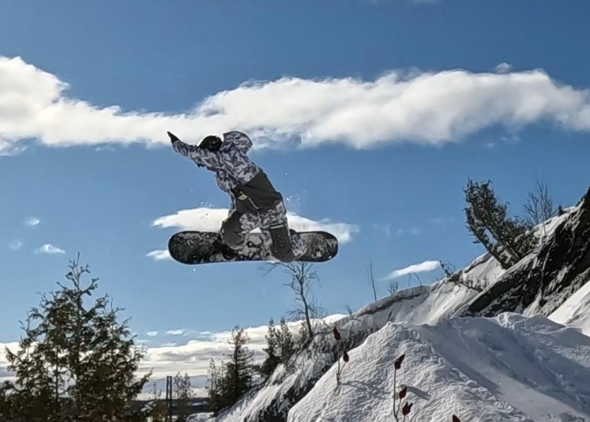 MHDUB rider Mathieu Morency doing a grab off a cliff