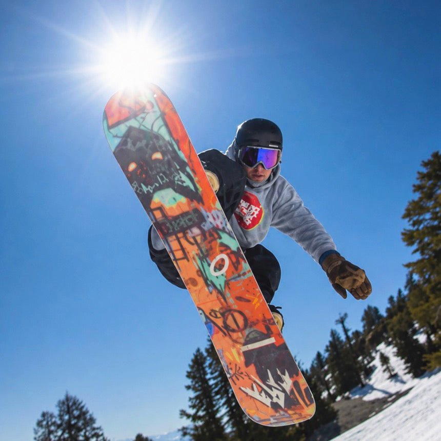 Gabe Taylor riding in MHDUB Backcountry Pro Tech goggles, method grab, with mirror lens