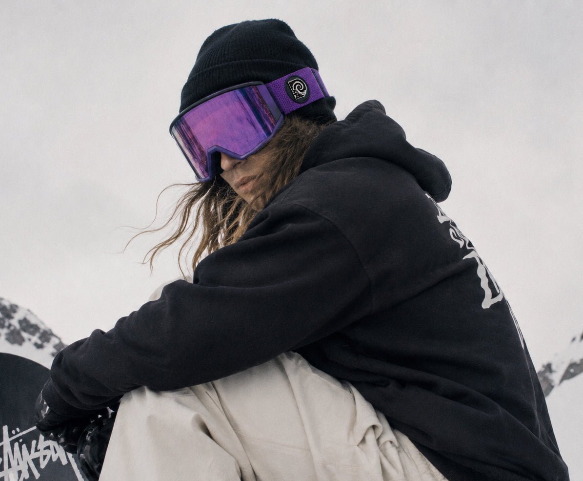 Snowboarder wearing Purple Haze snow goggles by MHDUB on snow